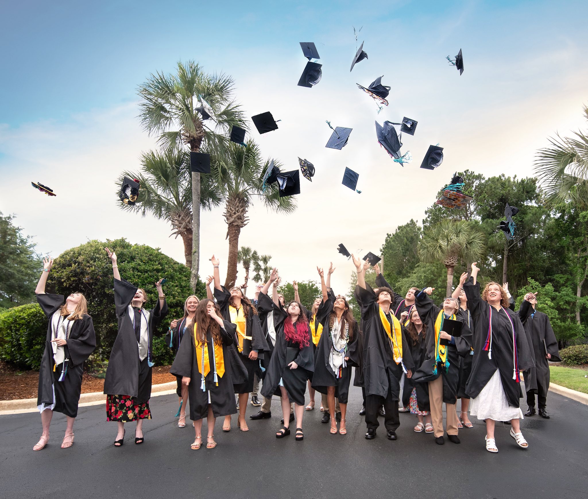 A group of graduates tossing their caps into the sky, Class of 2026
